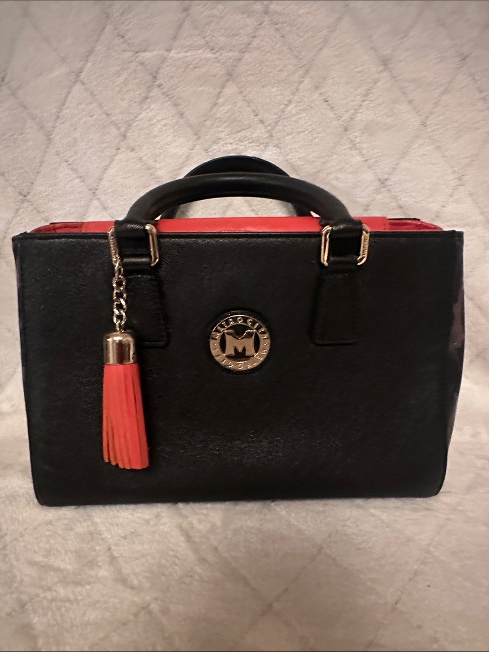 Structured Black Satchel with Orange Trim and Tassel Charm